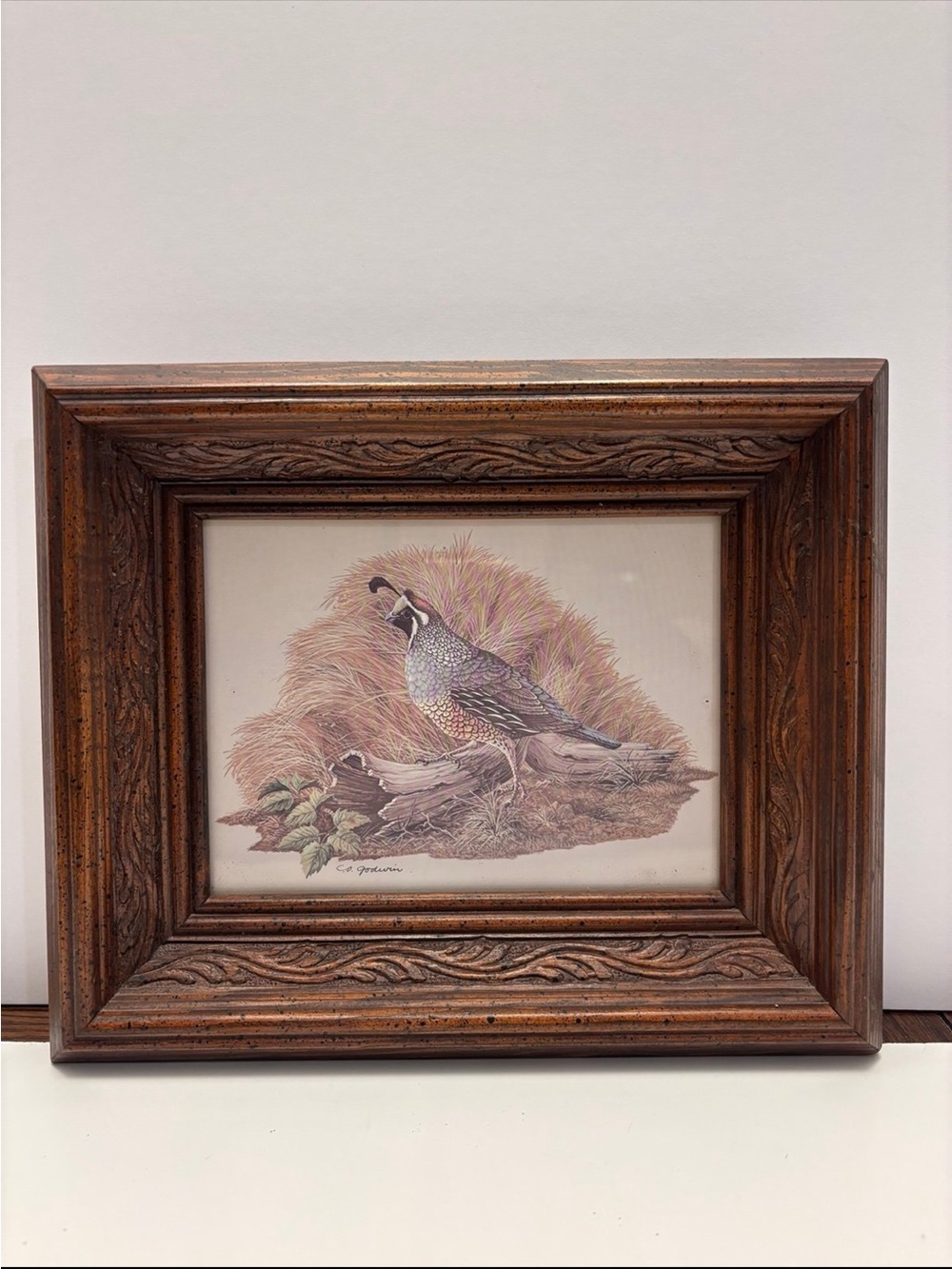 Vintage quail wall art with a rustic, carved wood frame
